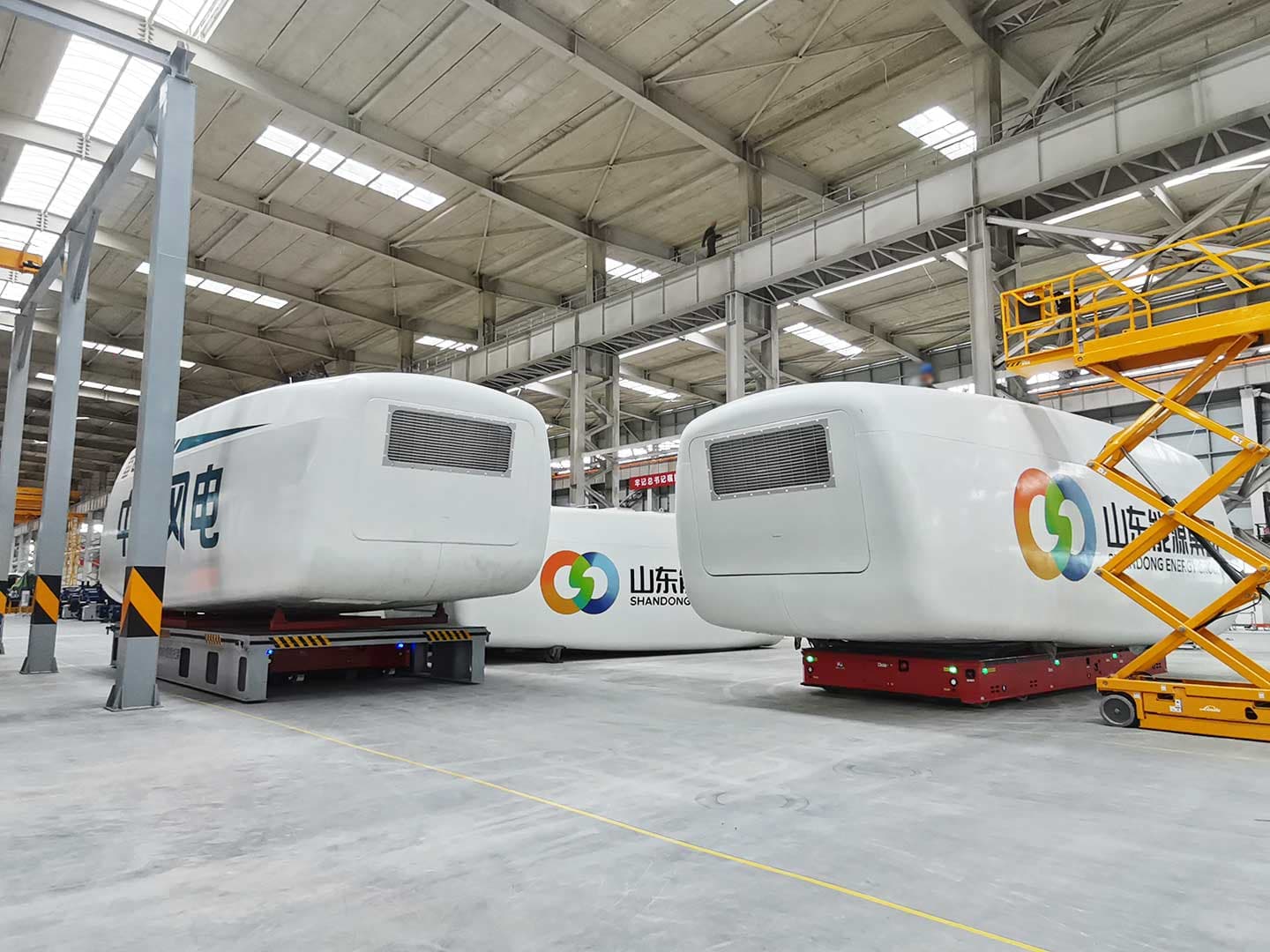Four wheeled transport vehicles are used for the transportation of wind turbine nacelle components-1